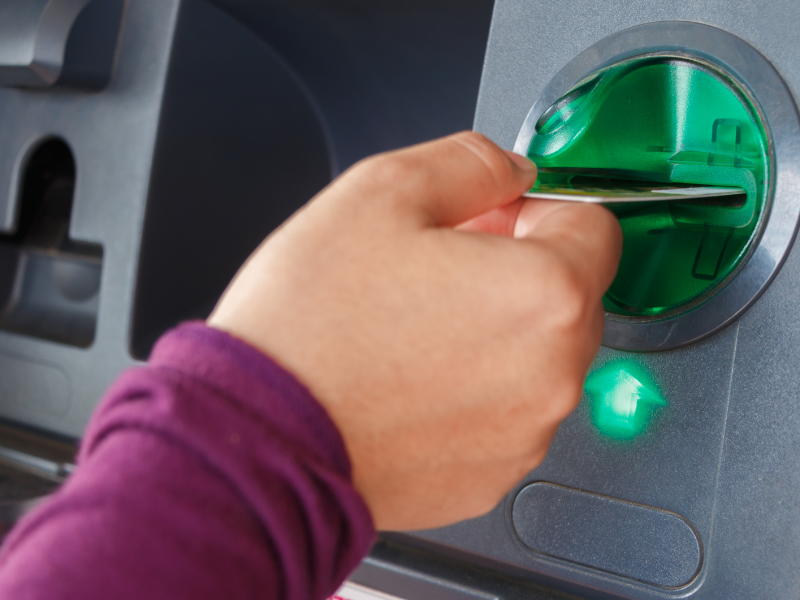 Credit Card Skimmer Someone swiping a credit card in a card reader.