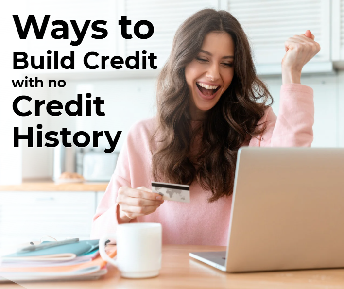 Excited young adult woman sitting at table with open laptop holding credit card.
